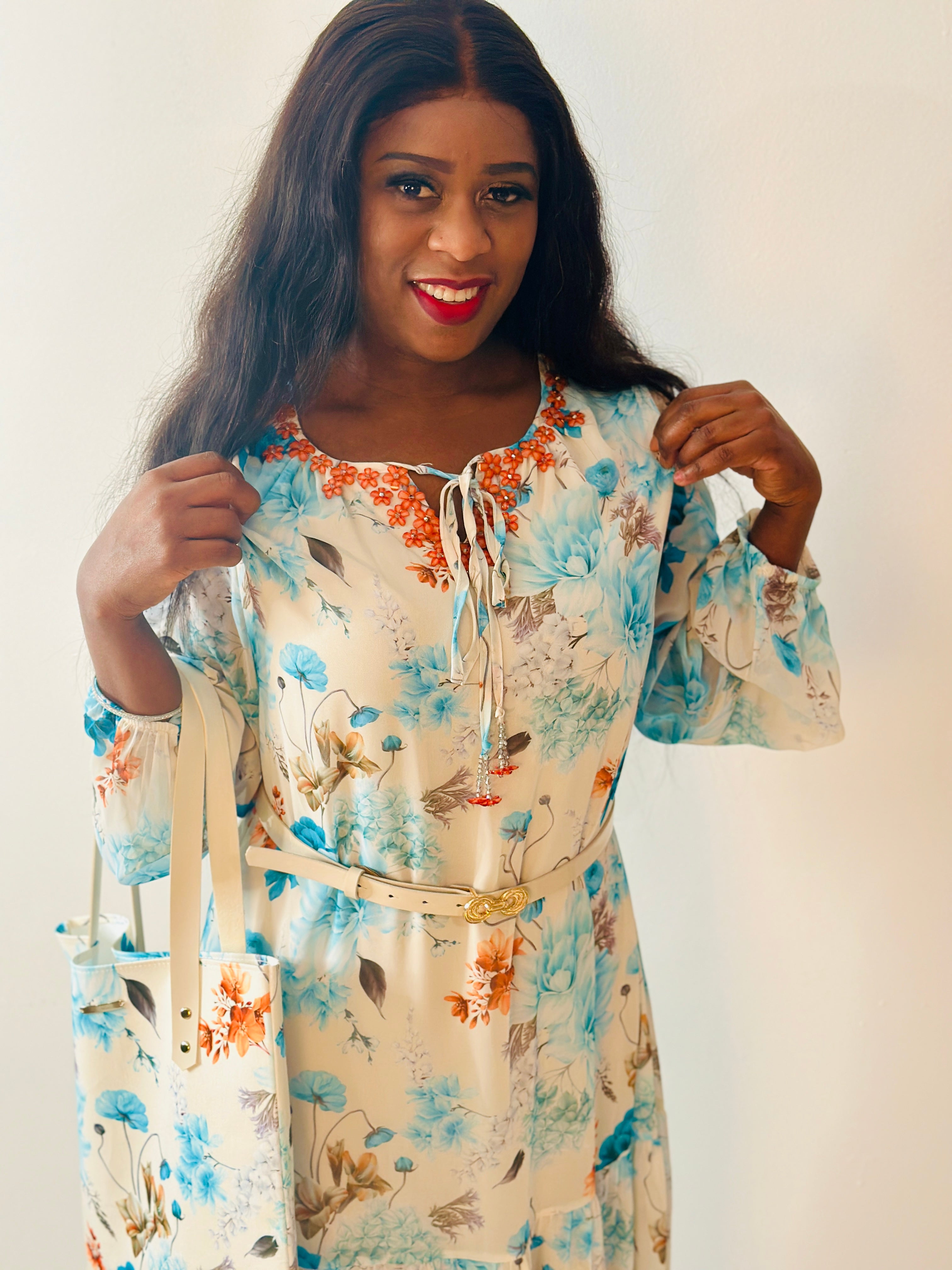 Grace Floral Maxi Dress model showcasing a soft floral print in aqua blue, coral, and cream tones.